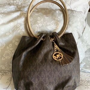 Michael Kors Brown Logo Bucket Bag Brown and Gold with Tassel Charm